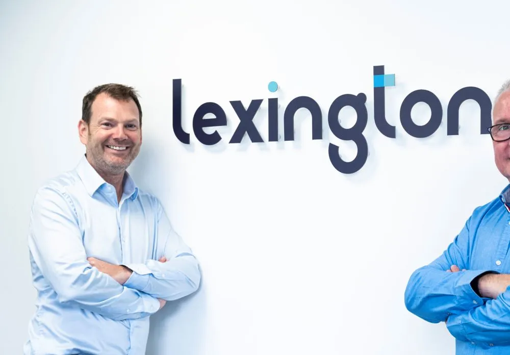 Some of the team standing in front of a Lexington sign.